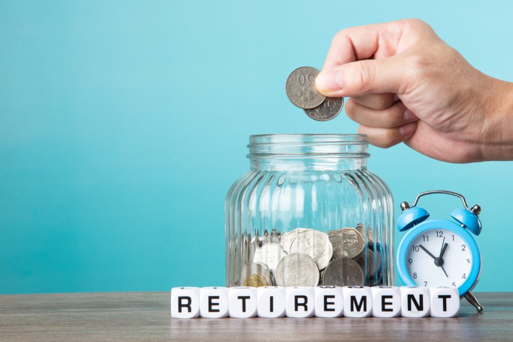 Person putting coins in a jar for retirement